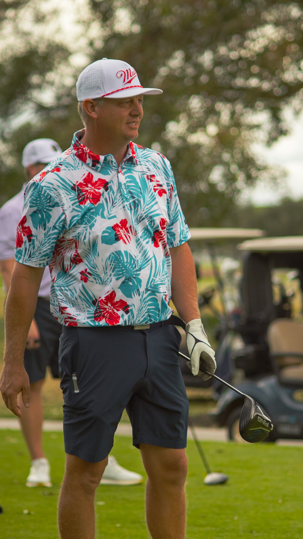 Player in a tropical polo holding a driver at the DFP Classic